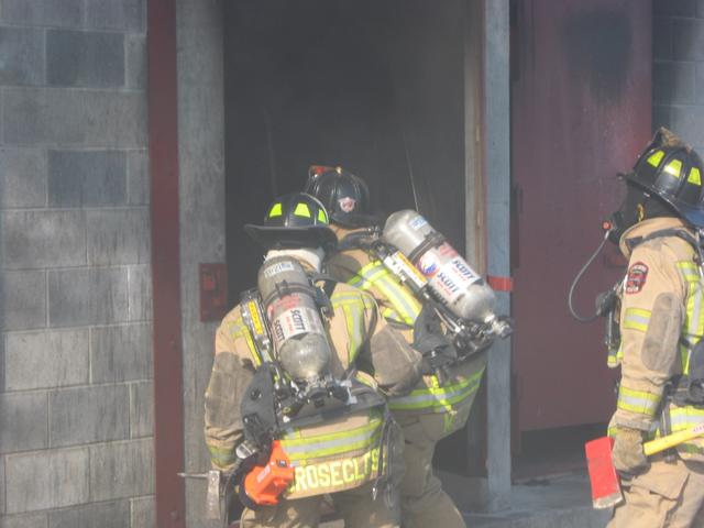 Crews making entry into the burn building.